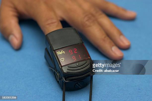 oximeter checking - saturated color stock pictures, royalty-free photos & images