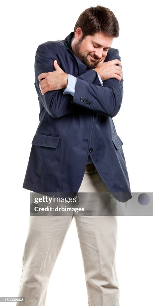 Portrait of adult male hugging himself