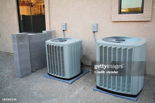 air conditioner pair - in central stock pictures, royalty-free photos & images