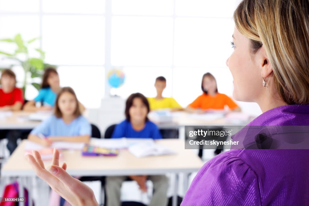 Teacher explanting to pupils a lesson