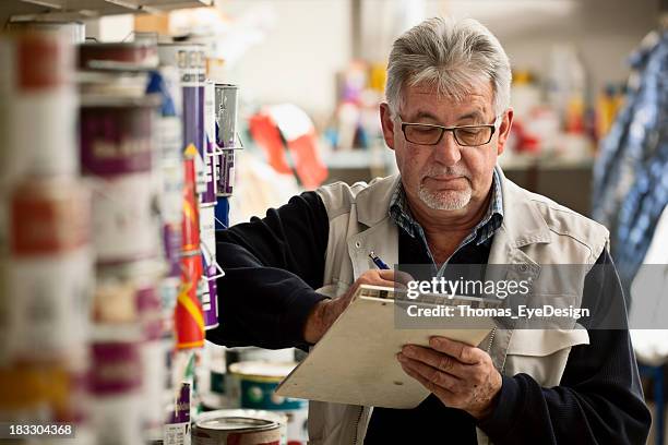 senior man taking inventory - senior decorating stock pictures, royalty-free photos & images