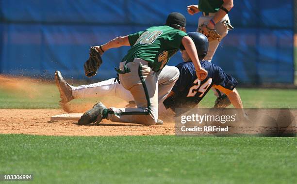 two baseball players playing a game of baseball - college baseball player stock pictures, royalty-free photos & images