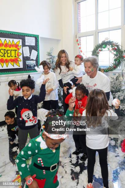 Guest, Patricia Caring and Richard Caring attend The Caring Family Foundation's "Food from the Heart" Campaign at Surrey Square Primary School with...