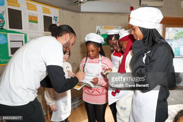 Kwajo Tweneboa and guest attend The Caring Family Foundation's "Food from the Heart" Campaign at Surrey Square Primary School with Bill's, The Ivy,...