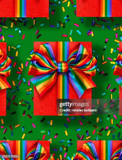 christmas presents wrapped with a rainbow bow - rainbow confetti stock pictures, royalty-free photos & images