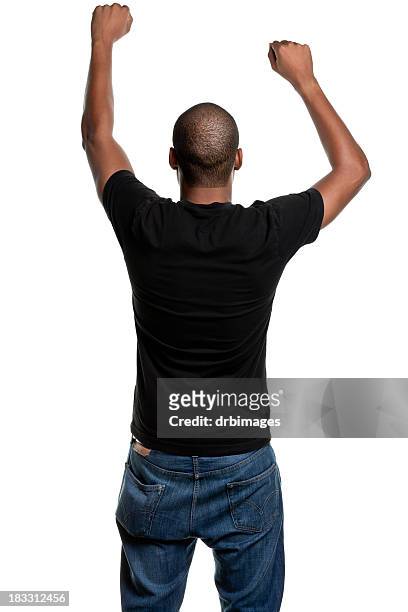 young man with arms up, shaking fists, rear view - rear view stock pictures, royalty-free photos & images
