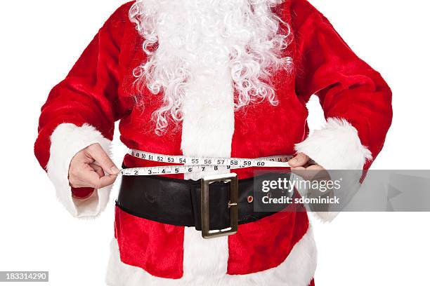 santa claus medición de la grasa de vientre - santa claus fat fotografías e imágenes de stock