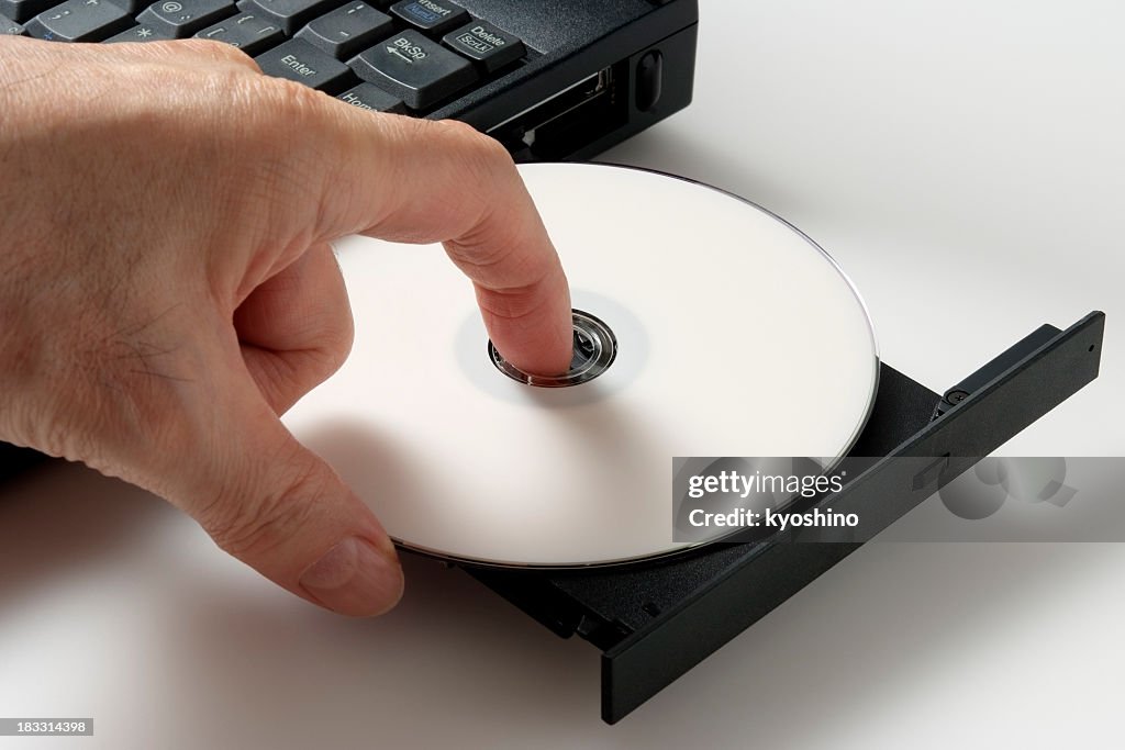 Insert Cd Computer Isolated Shot Of Inserting A Blank Cd On White Background High-Res ...