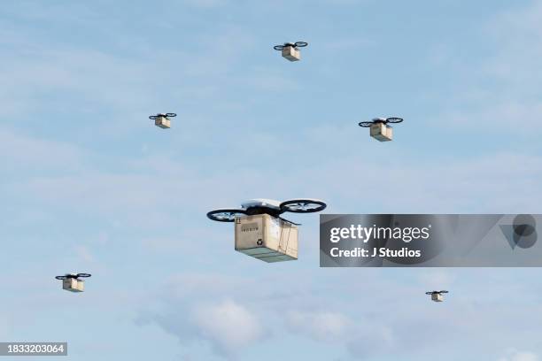 group of drones with packages - drone stock pictures, royalty-free photos & images