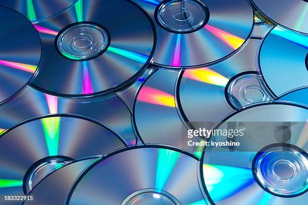 blue tinted image of stacked cd/dvd texture background - rom stock pictures, royalty-free photos & images