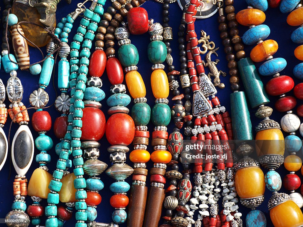 A bunch of colorful street jewelry on a table