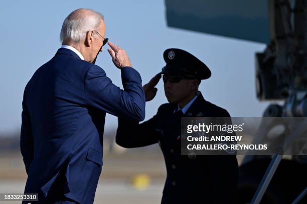 President Joe Biden salutes while boarding Air Force One at Joint Base Andrews in Maryland on December 8, 2023. Biden will travel to Las Vegas,...