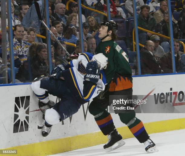 Dallas Drake of the St. Louis Blues grabs his face after he was hit by Drake Berehowsky of the Phoenix Coyotes in the third period on March 6, 2003...