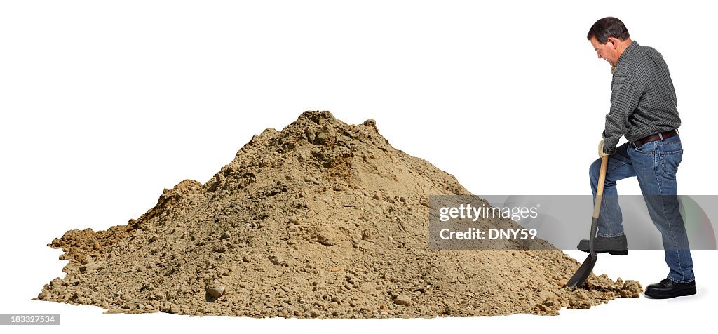 Middle aged man digging in pile of dirt using shovel