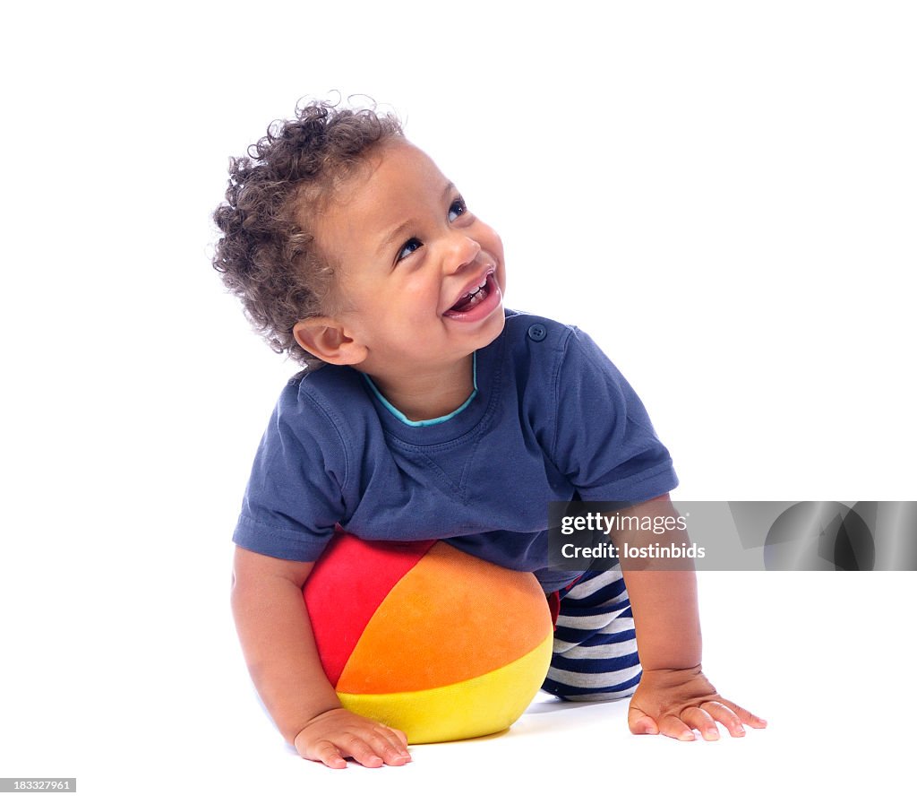 Baby Smiling And Looking Up While Playing With A Ball
