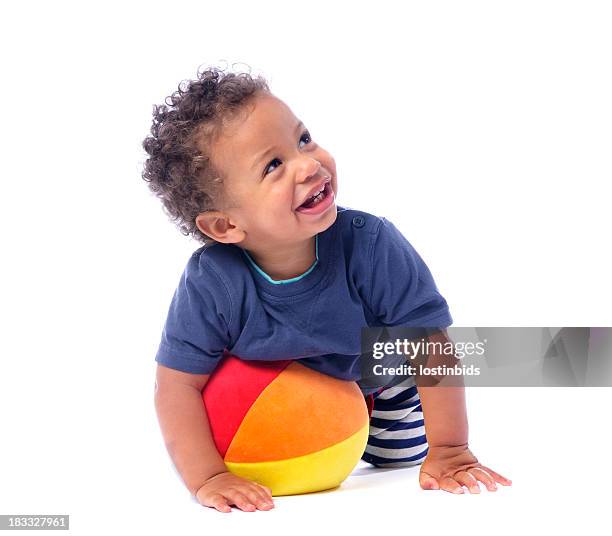 baby smiling and looking up while playing with a ball - toddlers playing stock pictures, royalty-free photos & images