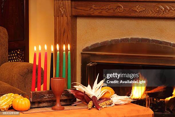 kwanzaa candles by fireplace left horizontal - kwanzaa stock pictures, royalty-free photos & images