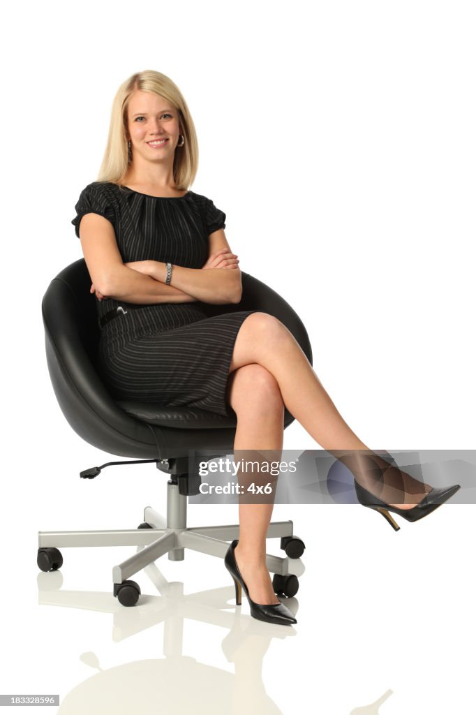 Confident business woman sitting in office chair