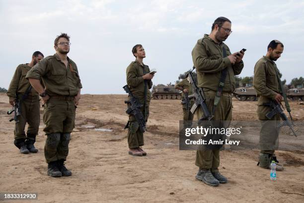 Israeli soldiers pray near the border with the Gaza Strip on December 8, 2023 in southern Israel. Israel and Hamas have resumed fighting after the...