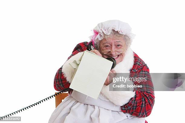 christmas: senior mrs claus notepad and phone - mrs claus stock pictures, royalty-free photos & images