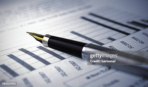 financial report graph with pen - tax scrutiny stock pictures, royalty-free photos & images