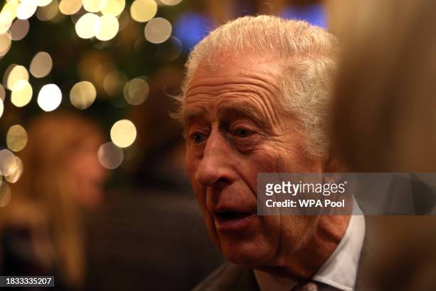 King Charles III speaks with students and tutors during a festive themed 'Celebration of Craft' at Highgrove House on December 8, 2023 in Tetbury,...