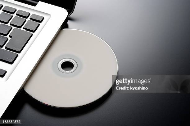 inserting a blank cd into a laptop with copy space - white rom stock pictures, royalty-free photos & images