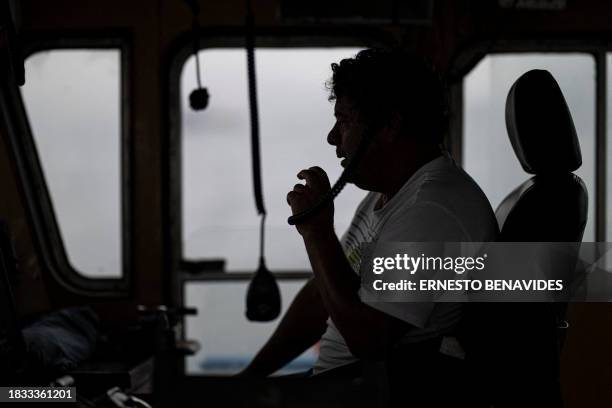 Luis Celis, captain of an anchovy boat, directs his workers while carrying out a fishing task aboard an anchovy boat out to sea after 5 miles in the...