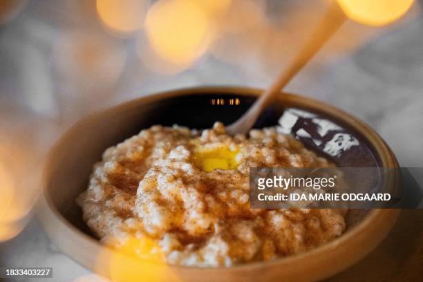 Photo taken on December 8, 2023 shows the traditional Danish Rice pudding Risengroed served with cinnamon sugar and a dollop of butter in Copenhagen,...