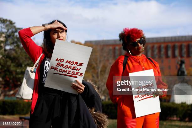 Activists hold up signs as they listen during a Title IX rally at Lafayette Park near the White House on December 05, 2023 in Washington, DC....