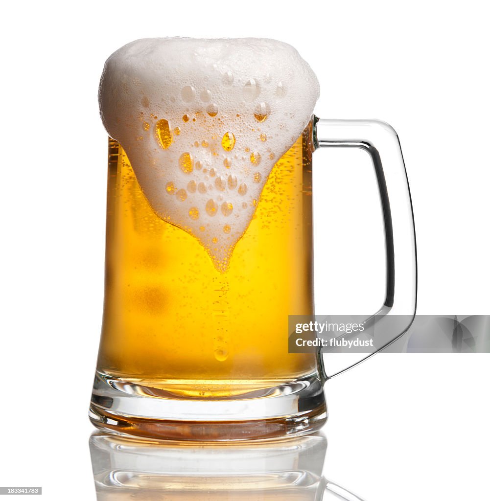 Beer glass with overflowing foam