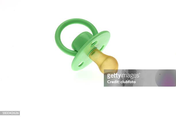 high key image of an infants green dummy or pacifier - baby isolated stockfoto's en -beelden