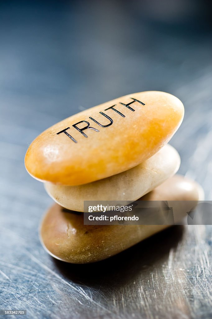 Three smooth, stacked stones with the top one saying truth