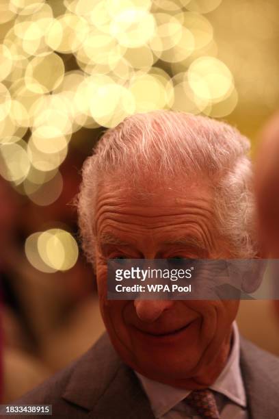 King Charles III speaks with students and tutors during a festive themed 'Celebration of Craft' at Highgrove House on December 8, 2023 in Tetbury,...