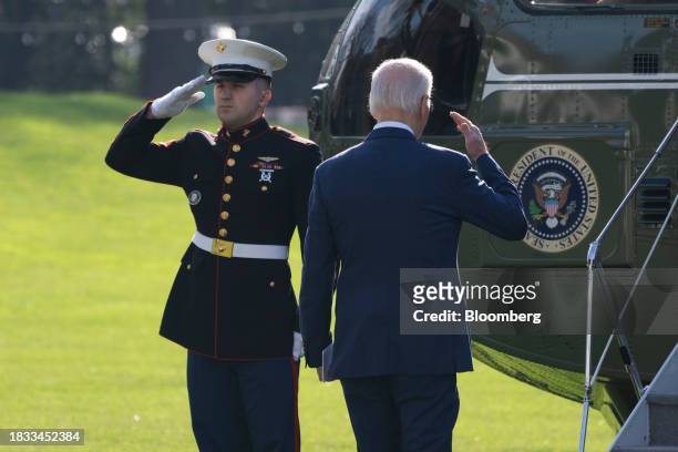 President Joe Biden salutes while boarding Marine One on the South Lawn of the White House in Washington, DC, US, on Friday, Dec. 8, 2023. House...