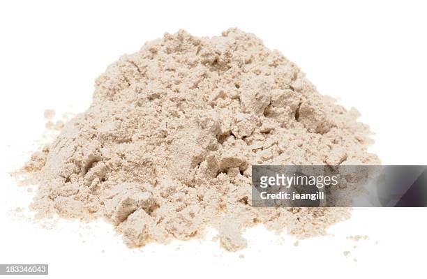 pile of buckwheat flour on a white background - boekweit stockfoto's en -beelden