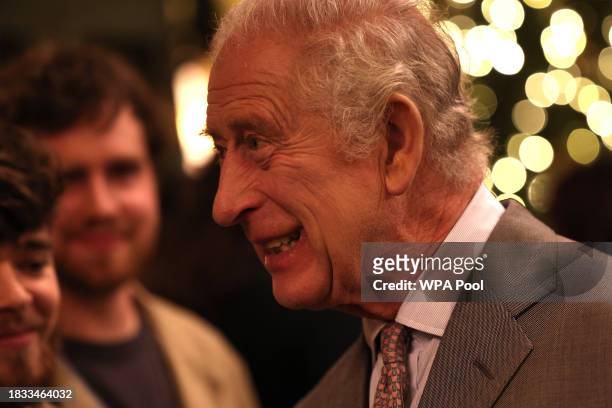 King Charles III speaks to students from Snowdon School of Furniture during a festive themed 'Celebration of Craft' at Highgrove House on December 8,...