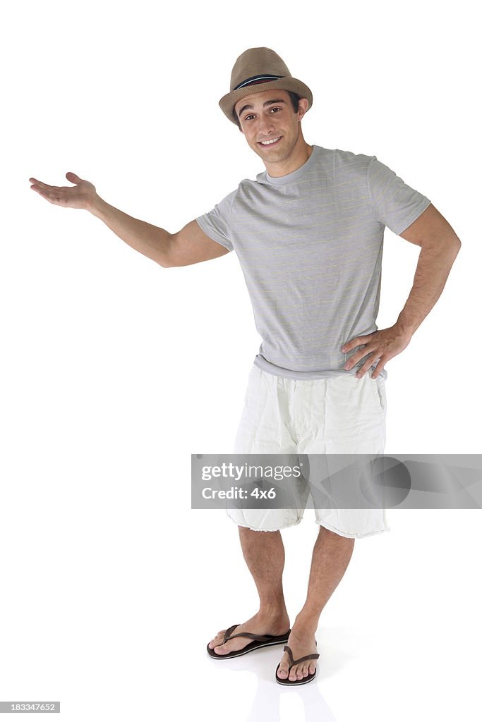 Isolated casual man with his hand out presenting