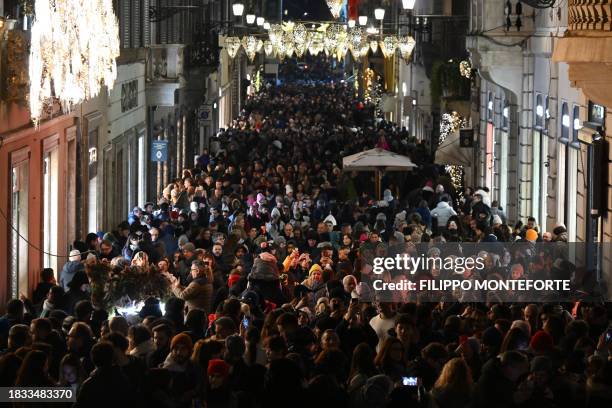 People stroll along the Via dei Condotti at the bottom of the Spanish steps in Rome during a public holiday for the feast of the Immaculate...