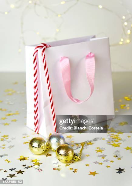 gift bag decorated with christmas motifs on a white background - she rocks awards stock pictures, royalty-free photos & images