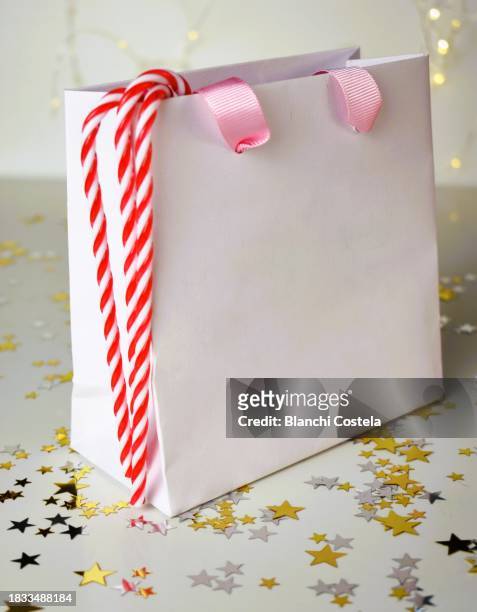 gift bag decorated with christmas motifs on a white background - she rocks awards stock pictures, royalty-free photos & images