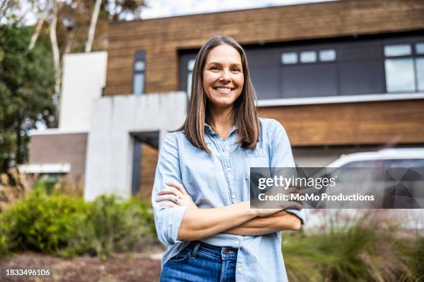 portrait of beautiful woman in front of modern home - i love my wife pics stock pictures, royalty-free photos & images
