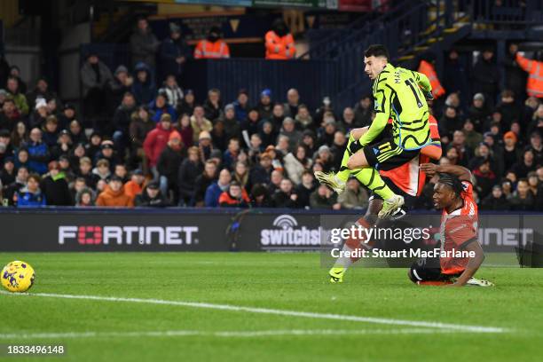 Gabriel Martinelli of Arsenal scores the team's first goal whilst under pressure from Teden Mengi of Luton Town during the Premier League match...