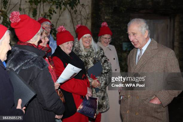 King Charles III chats with a choir of carol singers from Tetbury during a festive themed 'Celebration of Craft' at Highgrove House on December 8,...
