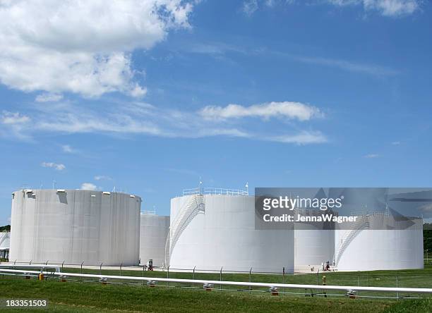 several white storage tanks in a grassy field - tone tank stock pictures, royalty-free photos & images