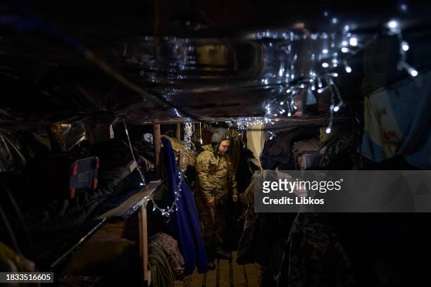 Ukrainian soldier with the call sign "Bodya" shows how he has prepared his trench for the New Year and Christmas holidays. On December 8, 2023 in...