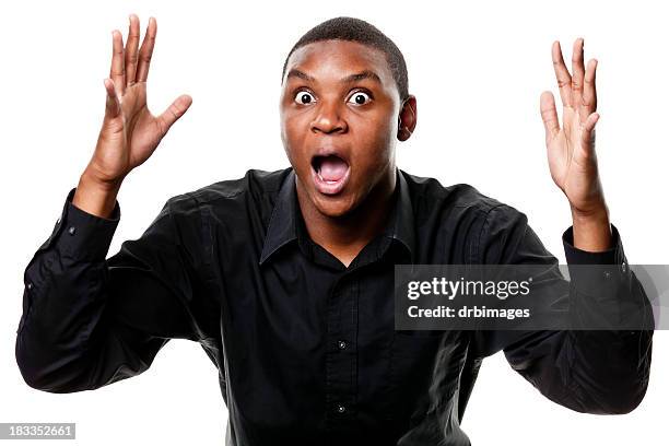 shocked young man gasping with arms up - man arms raised stock pictures, royalty-free photos & images