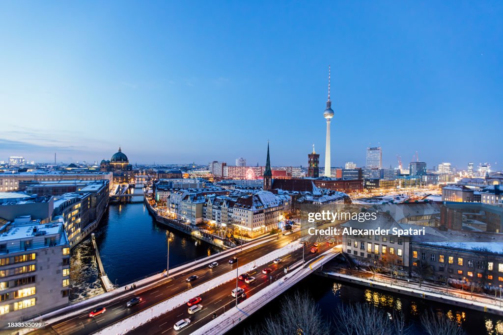 Aerial view of Berlin illuminated skyline at dusk in winter, Germany