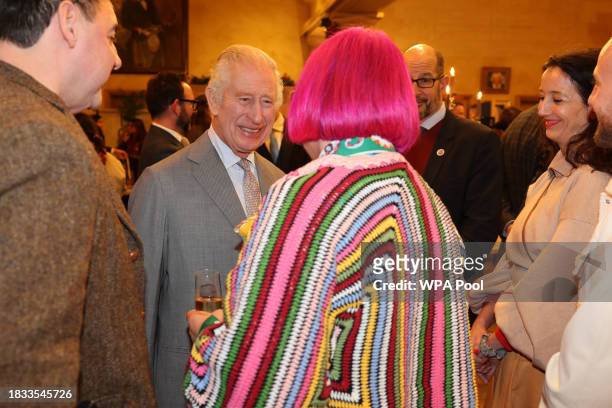 King Charles III speaks with tutors during a festive themed 'Celebration of Craft' at Highgrove House on December 8, 2023 in Tetbury, England. The...