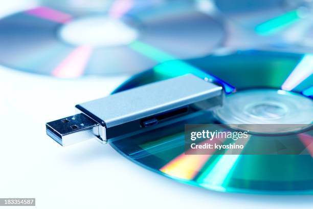 blue tinted image of usb flash memory with cd - cds stock pictures, royalty-free photos & images